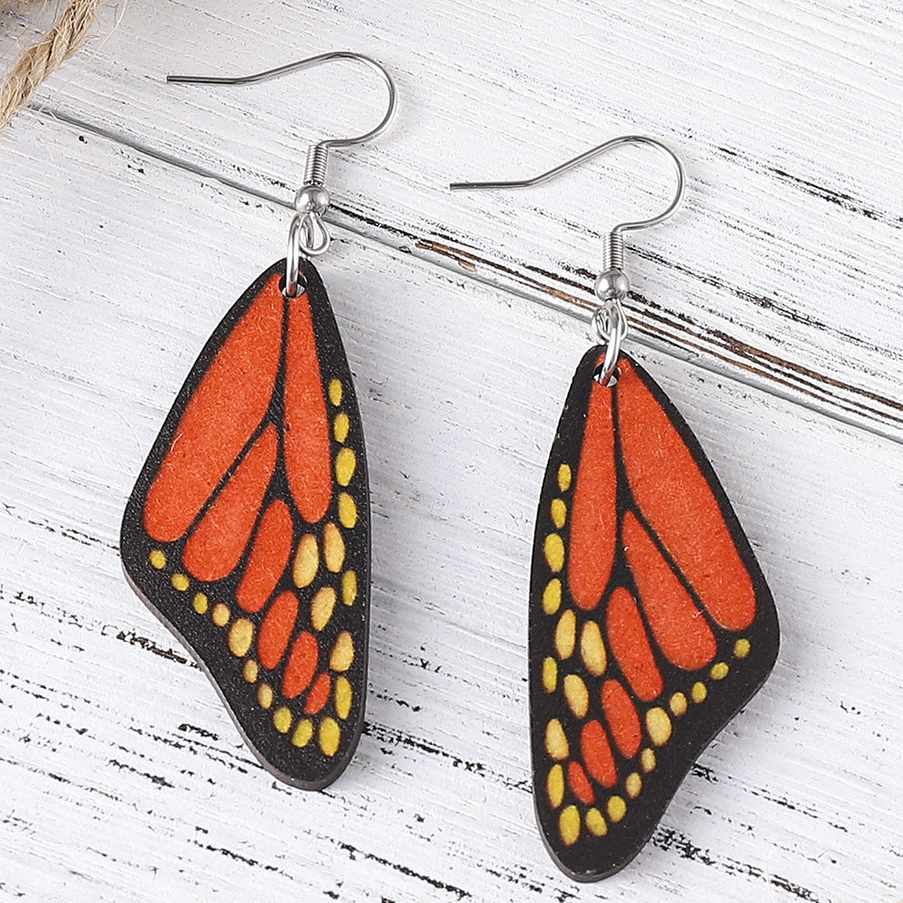 Alas de mariposa al por mayor Pendientes de madera de doble cara